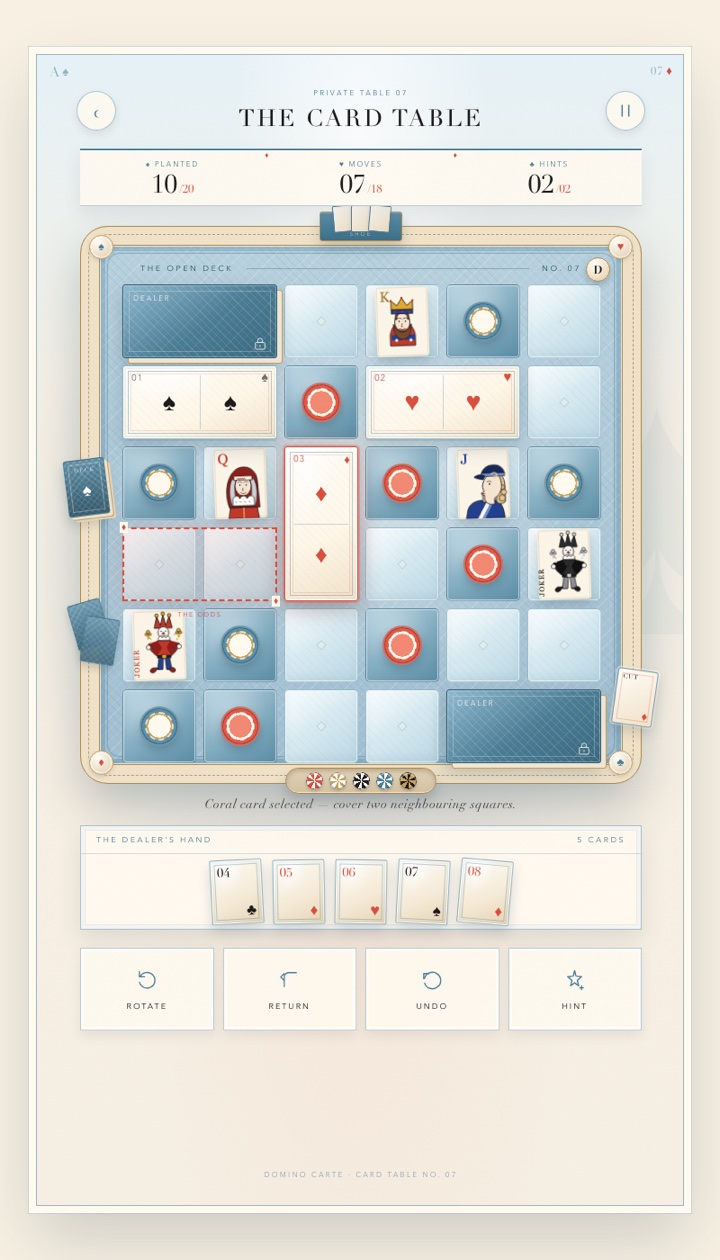 The Domino Carte table: a powder-blue six-by-six board framed by a cream card-table rail, with domino planters waiting in the tray.